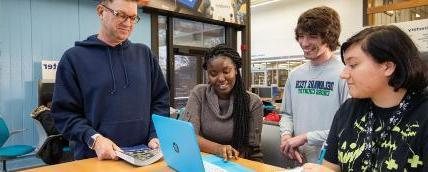 Students discuss coursework in the student learning center.