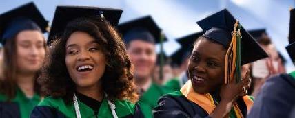 Two women in graduation regalia